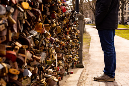 Many locks of love hang on the bridge. To prove their love, couples put padlocks on the railing of...