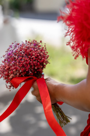 Red bouquet bridesmaid wedding procession Close-up beautiful bouquet womans hand streetの写真素材