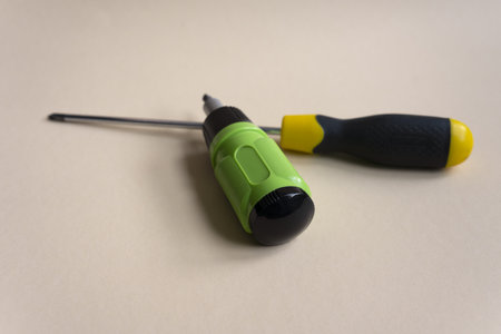 Two screwdrivers on a beige background. Two different screwdrivers. close-up.の写真素材