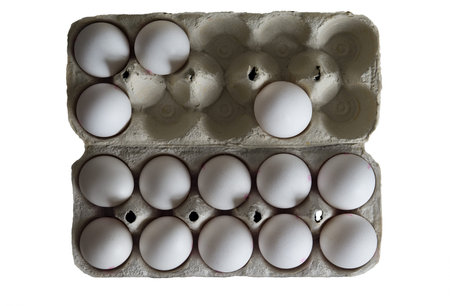 An open paper tray with chicken eggs that holds 14 white eggs.