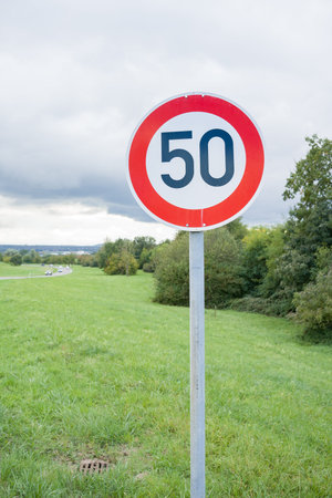 Traffic rules. Driving school. Compliance with speed. Road speed limit sign for vehicles.