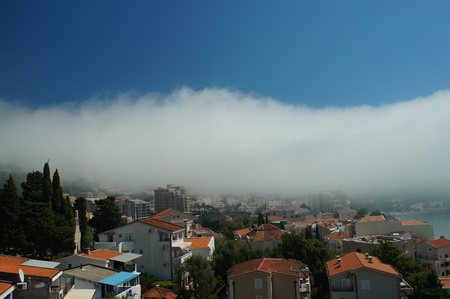 white cloud descended to the ground, the mysterious sky above the city near the seaの写真素材
