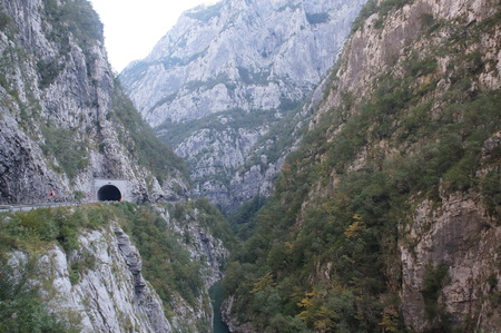 canyon, rocks and road passing through a tunnel in the rock, the river far belowの写真素材