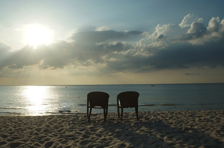 lonely chairs in the background of the sea, rest and relaxation on the beachの写真素材