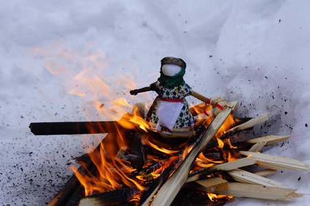 Burning doll Maslenitsa celebration in the Russian Orthodox rite in the snowの写真素材