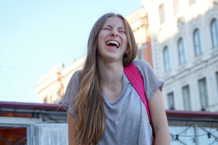 happiness on the face of the teenager, joyful laughter and excellent mood, happy day in the city