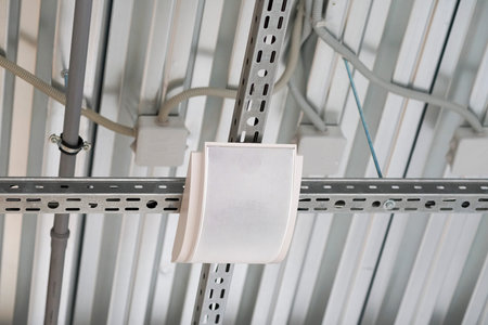 Ceiling frame made of metal profiles, electrical wires running across the ceiling