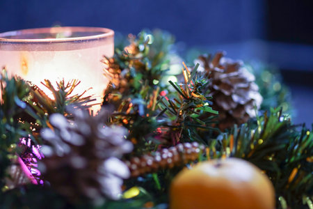 burning candle and citrus in a green tree decoration on the table, the preparation of a flavored...