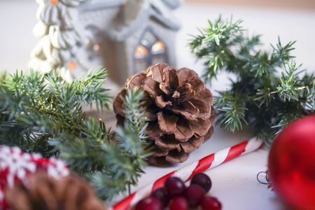 Christmas table decoration,Christmas balls with fir branch and candle on wooden backgroundの写真素材