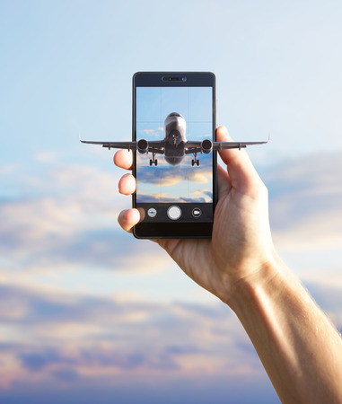 Airplane flying out the smartphone.の写真素材