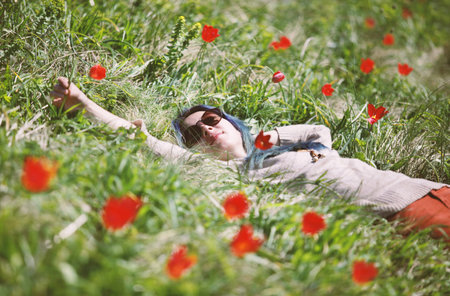Girl lying in tulip field.