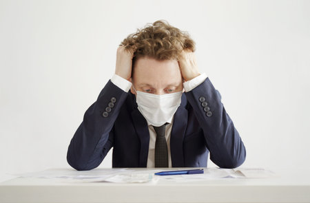 Stressed Businessman in Face Mask. Lockdown Coronavirus Concept.