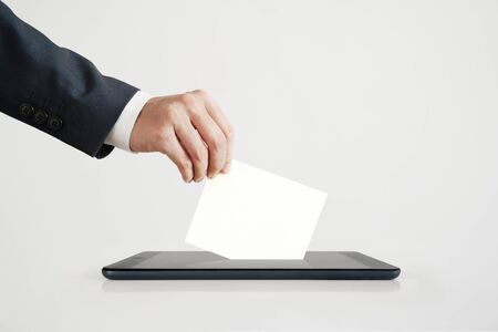 Businessman Voting Online Using Digital Tablet.の写真素材