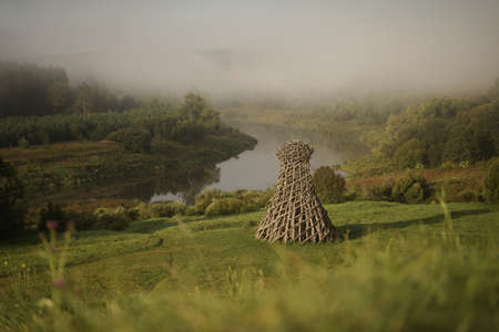 Russia, Nikola-Lenivets - 13 August 2019. Wooden sculpture Â«LighthouseÂ» in the Art Park Nikola Lenivets in morning light. Kaluga Region, Russia.のeditorial素材