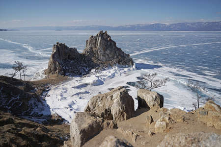 Lake Baikal at winter. View on Burkhan Cape and Shaman Rock. Deepest and largest fresh water lake. Olkhon Island, Russia, Siberia.の写真素材