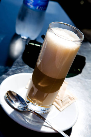 Glass of hot coffee latte outdoors