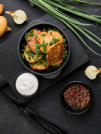 Delicious onion fritters with sour cream and green onion on plate, closeupの写真素材
