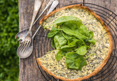 Quiche with spinach - traditional dish of french cuisine. Spinach tart