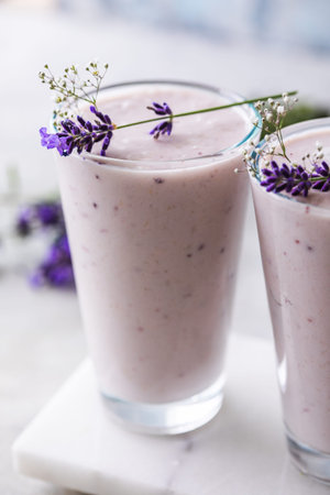 Lavender smoothie with coconut milk, blueberry. Vegan beverageの写真素材