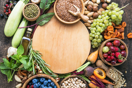 Vegetarian ingredients for cooking. Flat vegetables, fruits, beans, cereals, kitchen utensils, dried flowers, olive oil on a wooden background, top view. Clean, healthy foodの写真素材