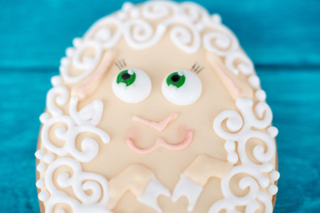 A little sheep. one Easter cookie on blue wooden background