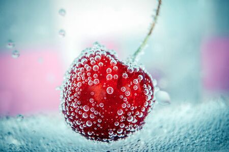 Cherry in a bubbles with sweet backgroundの写真素材