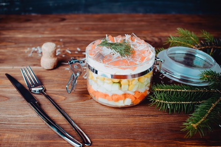 Sophisticated salmon salad with champagne, parmesan and fork in a bottle on a wooden backgroundの写真素材