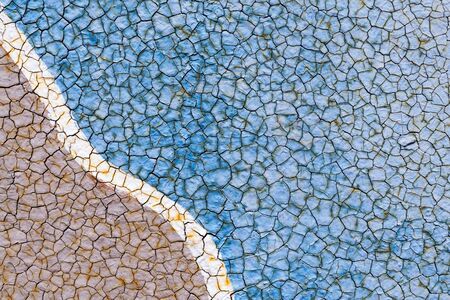 Peeling paint on wall with wavy pattern texture. Pattern of rustic blue and grey grunge material.の写真素材