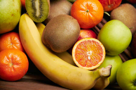 Tropical fruit on black wooden background, top view. Selective focus.の写真素材
