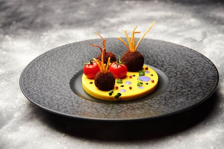 meatballs with tomato sauce in black pan in backgraundの写真素材