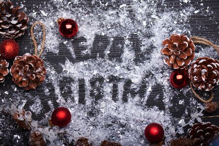 Christmas card. Christmas sign with ginger cookies on a wooden background with artificial snow. Christmas treat decorating. Top view.の写真素材