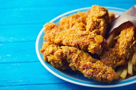Crispy fried chicken breast on an old rustic wooden background, Close up. With a lot of copy space.の写真素材