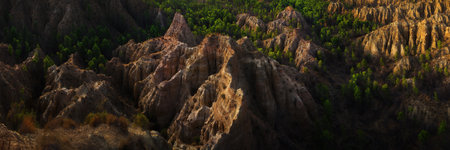 panoramic view over rocky mountains among a green pine forest and amazing formationsの写真素材