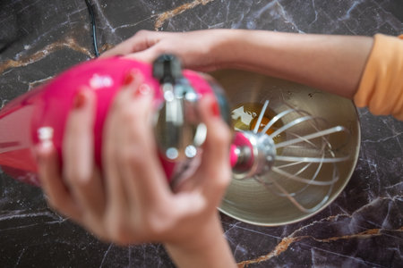 woman using big mixer to make muffinsの写真素材