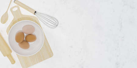wooden kitchen accessories with a bowl with eggs inside and white marble background with space for text. 3d renderingの写真素材