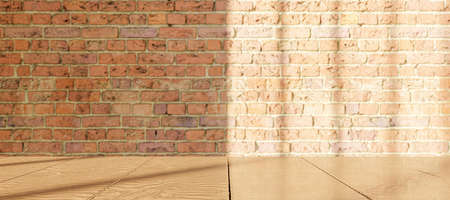 wooden table with blurred brick wall with window illumination. product display. 3d renderの写真素材