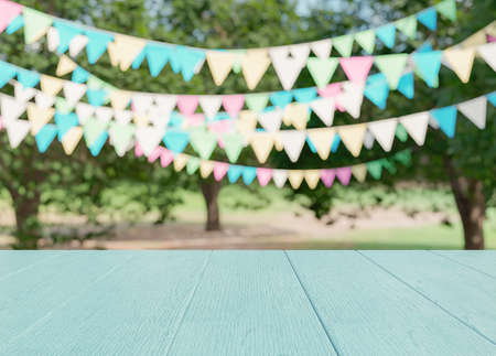 Empty wooden table with party in gardenの写真素材
