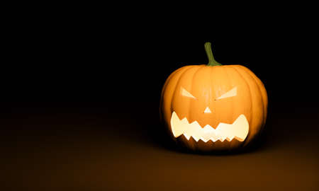 Halloween pumpkin with illuminated scary face on dark background and space for text. 3d renderingの写真素材