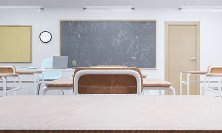 table top in a school classroom with blackboard in the background. concept of education and back to school. 3d renderingの写真素材