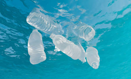 plastic bottles floating under sea water. concept of pollution, ecology, recycling and environment....