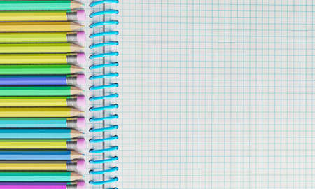 top view of notebook with multicolored pencils on one side. space for text. education concept. 3d renderingの写真素材