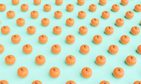 pumpkin pattern on green pastel background. autumn concept. 3d renderingの写真素材