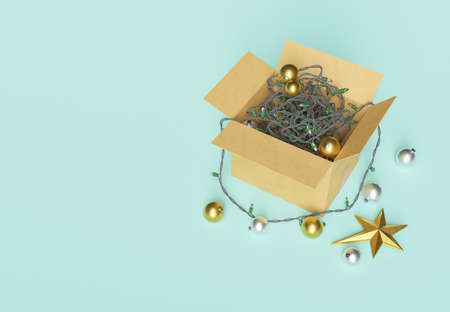 open box of christmas decorations with twisted lights and ornaments on the floor. christmas arrival...
