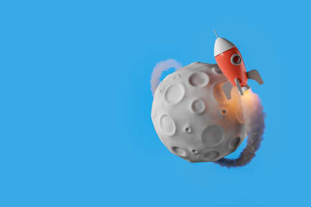 small rocket orbiting the moon and leaving a trail of smoke. copy space. 3d renderingの写真素材