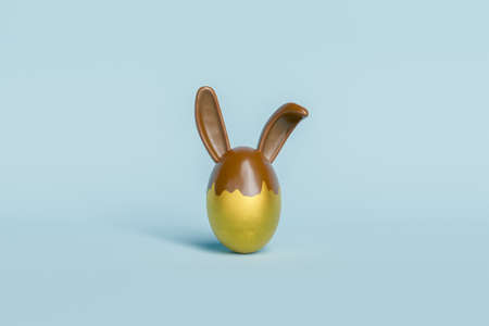 golden easter egg with chocolate bunny ears. 3d rendering