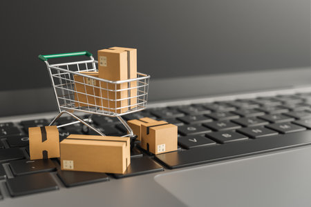 close up of shopping cart on top of computer keyboard with shipping boxes around it and copy space. concept of e-commerce, shipping, drop shipping and retailers. 3d renderingの写真素材