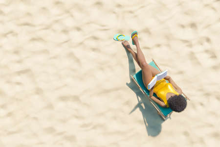 3D rendering aerial view of unrecognizable African American female tourist with curly hair in yellow swimsuit relaxing on lounger and reading interesting book on sunny day on sandy beachの写真素材