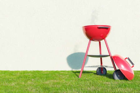 3D rendering of modern portable metal red grill oven with smoke placed on grassy lawn near white wall on sunny summer day during picnicの写真素材