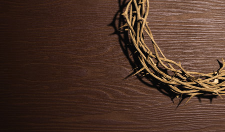 3D rendering top view half of crown of thorn placed on brown wooden surface made of dry tree branchesの写真素材