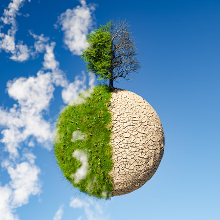 mini planet with one half green and cloudy and the other half dry and cracked mud desert. concept of global warming, climate change and drought. 3d renderingの写真素材
